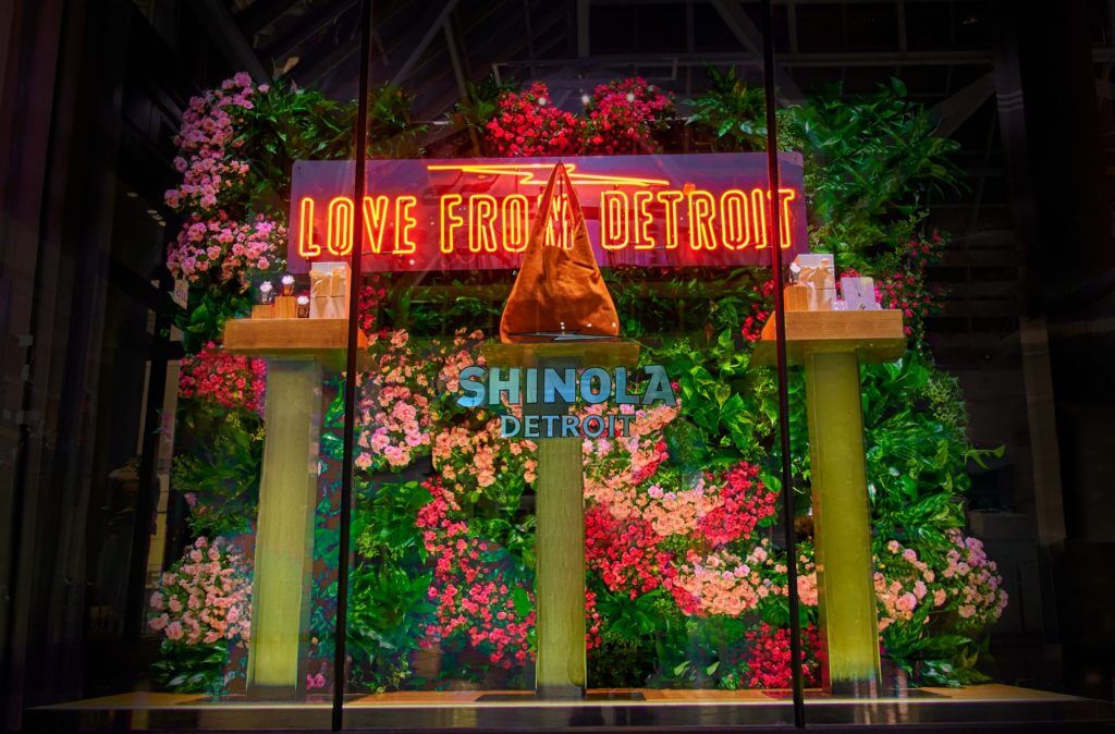 The live plant backdrop highlights the genuine Shinola products at this store.