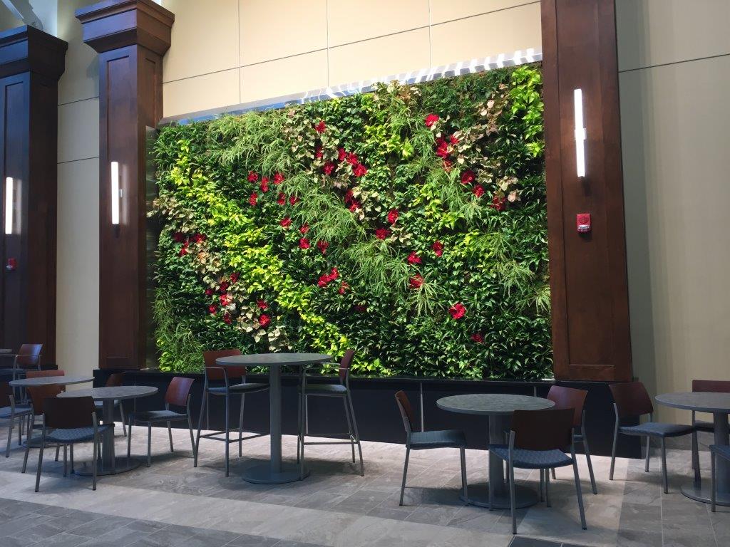 Living Wall System at Henry Ford Detroit with a large indoor vertical garden and seating area.